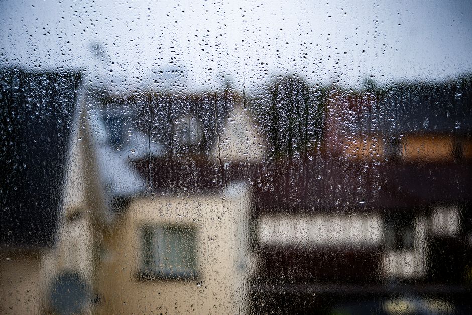 Blurred view of a rainy day in Bournemouth, capturing raindrops on a window.